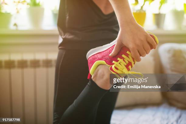 young woman getting ready for training - checking sports stock pictures, royalty-free photos & images