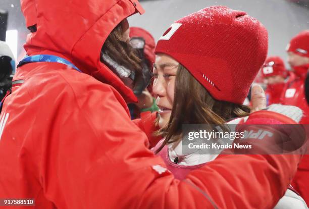 Sara Takanashi of Japan bursts into tears in the arms of her coach Izumi Yamada after winning the bronze medal in the women's normal hill individual...