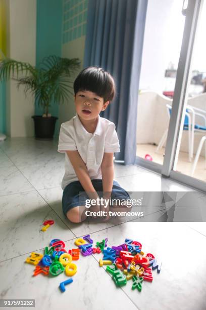 child with alphabet magnet toys. - number magnet stock pictures, royalty-free photos & images