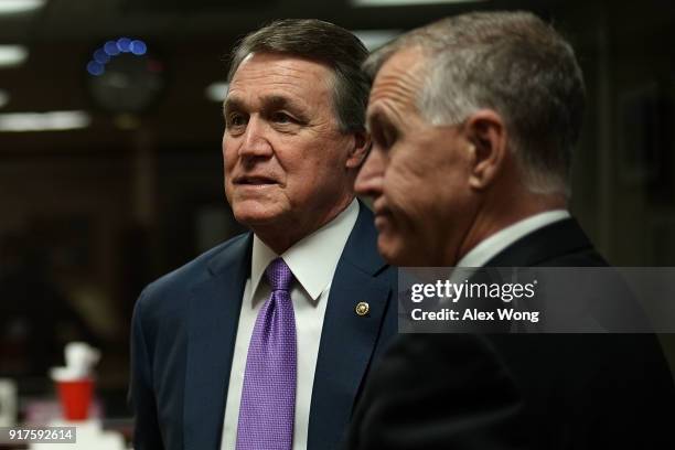 Sens. David Perdue and Thom Tillis wait for the beginning of a news conference on immigration February 12, 2018 at the Capitol in Washington, DC....