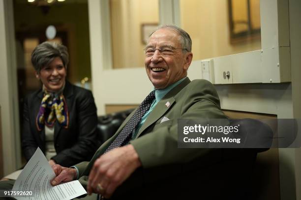 Sens. Chuck Grassley and Joni Ernst wait for the beginning of a news conference on immigration February 12, 2018 at the Capitol in Washington, DC....