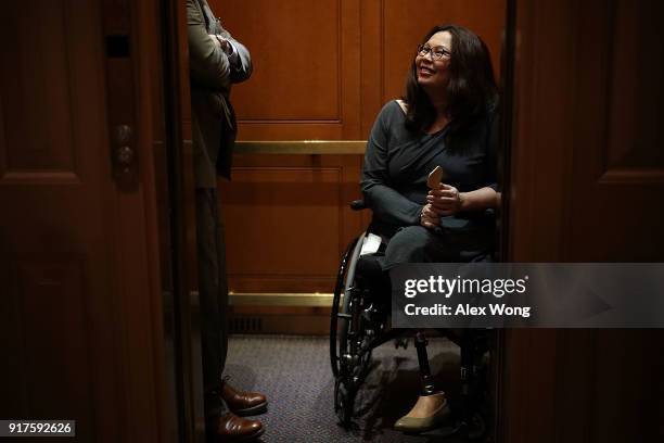 Sen. Tammy Duckworth leaves on an elevator after a vote at the Capitol February 12, 2018 in Washington, DC. The Senate has passed a procedural vote...