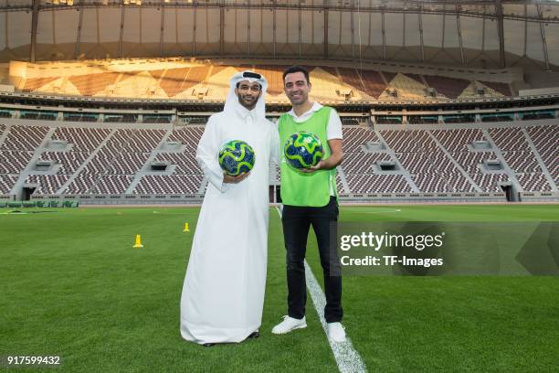 Secretary General Hassan Al Thawadi and Xavi Hernandez look on during a media meeting at the Khalifa International Stadium on January 05, 2018 in...