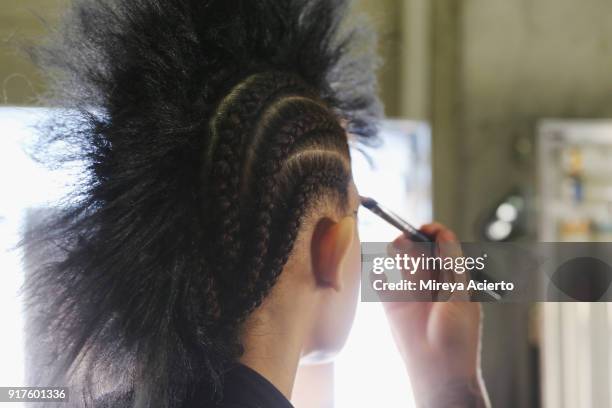 Model prepares backstage during the Kaimin fashion show at the Glass Houses on February 12, 2018 in New York City.