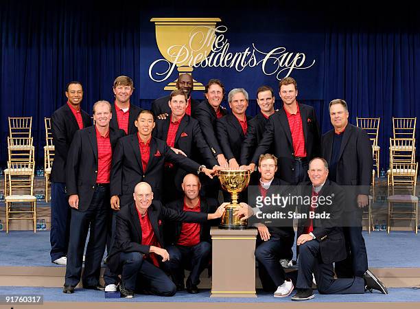 Members of the USA Team pose on stage at the closing ceremonies after the USA defeated the International Team 19.5 to 14.5 to win The Presidents Cup...