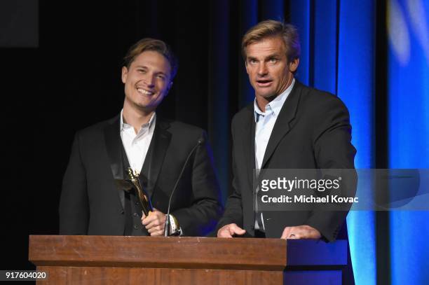 Actor Elijah Allan-Blitz and professional surfer Laird Hamilton accept the 2018 Lumiere award for Best Sports VR Experience onstage at the Advanced...