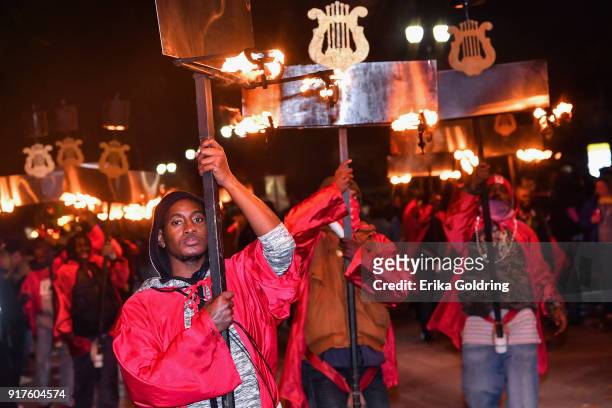 Flambeaux light the streets in the 2018 Krewe of Orpheus Parade, the krewe's 25th anniversary, on February 12, 2018 in New Orleans, Louisiana.