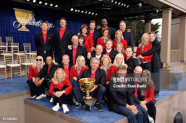 Members of the USA Team pose with their wives on stage at the closing ceremonies after the USA defeated the International Team 19.5 to 14.5 to win...