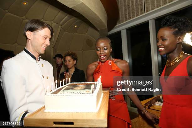 Actress Danai Gurira blows out the candles on her birthday cake as Lupita Nyong'o looks on during the DANAI x One x Love Our Girls celebration at The...