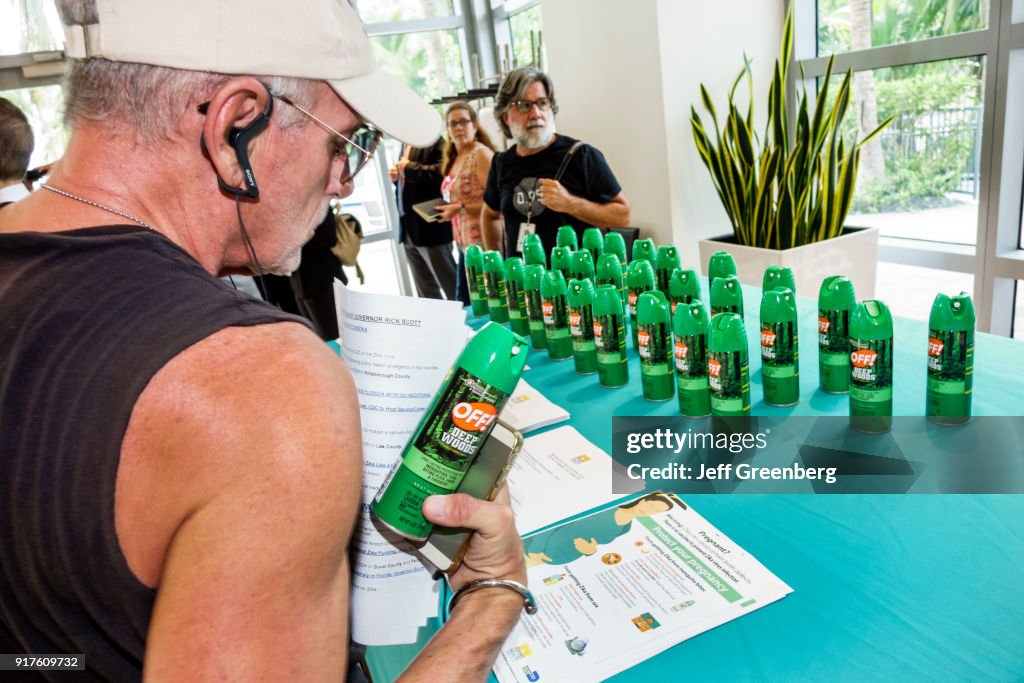 A man looking at the free mosquito spray OFF! Being given out at the Zika Virus Town Hall Meeting at Waverly Condominiums.