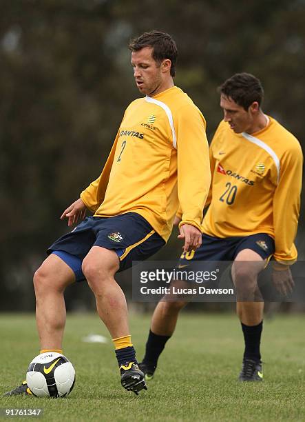 Lucas Neill of the Socceroos controls the ball at an Australian Socceroos training session at Monash University on October 12, 2009 in Melbourne,...
