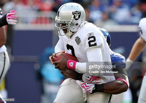 Justin Tuck of the New York Giants sacks JaMarcus Russell of the Oakland Raiders in the third quarter on October 11, 2009 at Giants Stadium in East...