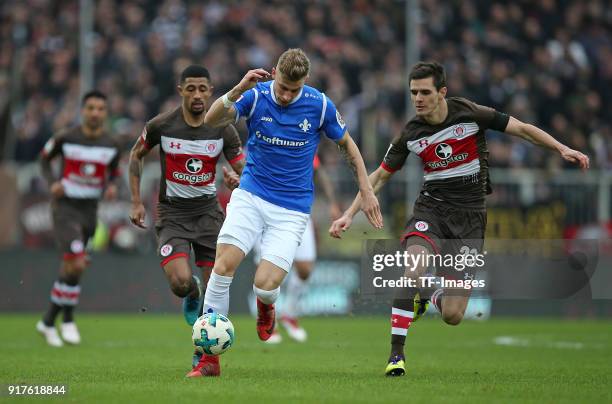 Jeremy Dudziak of St. Pauli, Felix Platte of Darmstadt and Johannes Flum of St. Pauli battle for the ball during the Second Bundesliga match between...