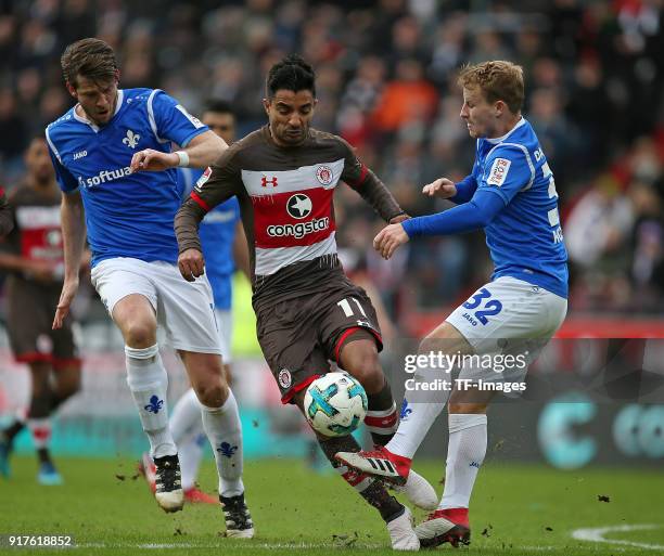 Peter Niemeyer of Darmstadt, Sami Allagui of St. Pauli and Fabian Holland of Darmstadt battle for the ball during the Second Bundesliga match between...