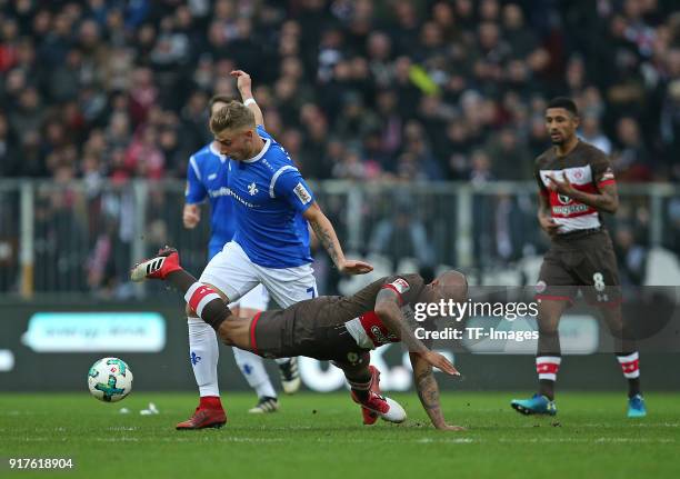 Felix Platte of Darmstadt and Christopher Avevor of St. Pauli battle for the ball during the Second Bundesliga match between FC St. Pauli and SV...