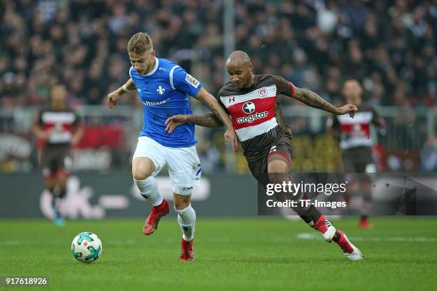 Felix Platte of Darmstadt and Christopher Avevor of St. Pauli battle for the ball during the Second Bundesliga match between FC St. Pauli and SV...