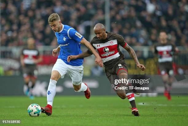 Felix Platte of Darmstadt and Christopher Avevor of St. Pauli battle for the ball during the Second Bundesliga match between FC St. Pauli and SV...