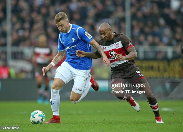 Felix Platte of Darmstadt and Christopher Avevor of St. Pauli battle for the ball during the Second Bundesliga match between FC St. Pauli and SV...