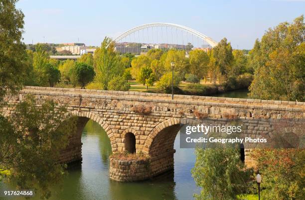 Modern bridge behind Puente Romano, Roman bridge crossing, Rio Guadiana River, Merida, Extremadura, Spain.