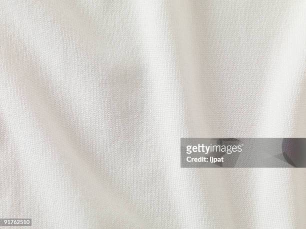 a close-up of white fabric forming a background - shirt stock pictures, royalty-free photos & images
