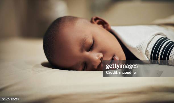 alle tuckered out - boy asleep in bed stock-fotos und bilder