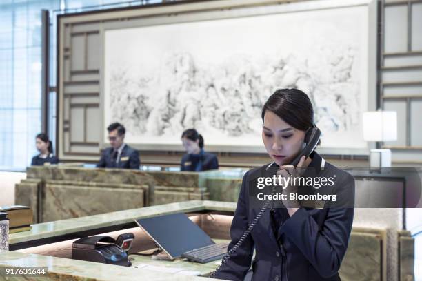 Receptionists work at a counter of the MGM Cotai casino resort, developed by MGM China Holdings Ltd., outside the casino resort in Macau, China, on...