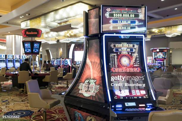 Slot machines stand on the gaming floor of the casino at the MGM Cotai casino resort, developed by MGM China Holdings Ltd., in Macau, China, on...