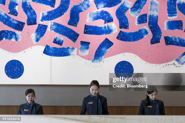 Receptionists work at a counter of the MGM Cotai casino resort, developed by MGM China Holdings Ltd., outside the casino resort in Macau, China, on...