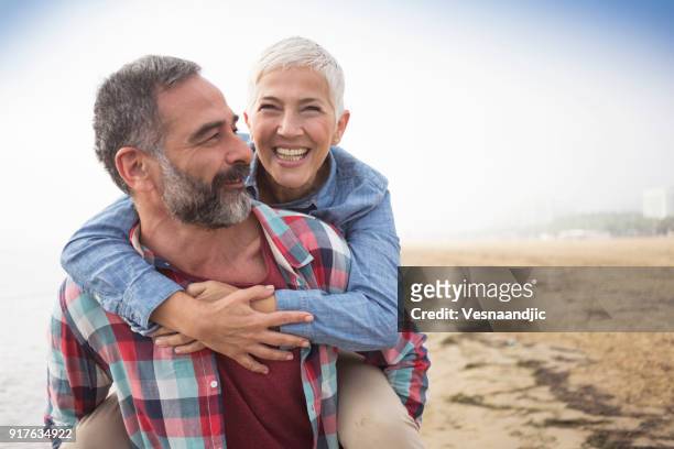 love is always playful - active seniors beach stock pictures, royalty-free photos & images