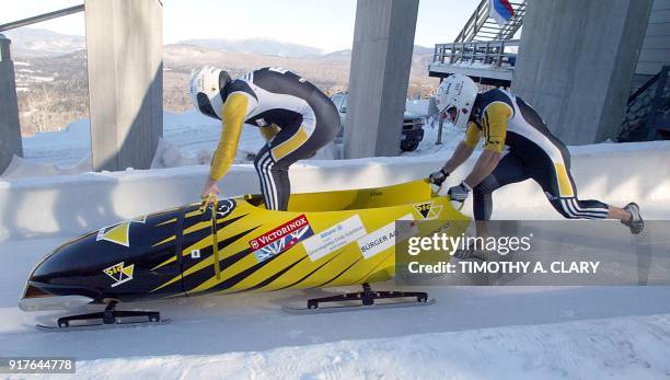 The Swiss two-man bobsled team of Annen Martin and Cedric Grand push off at the start during the 1st day of competition 15 February 2003 for the 2003...