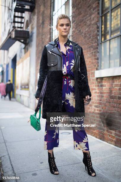 Nina Agdal is seen on the street attending Zadig & Voltaire during New York Fashion Week wearing a royal blue pattern outfit with black coat on...