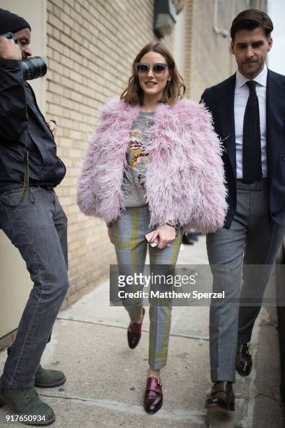 Olivia Palermo and Johannes Huebl are seen on the street attending Ralph Lauren during New York Fashion Week wearing a pink faux-fur jacket with...