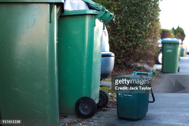 Surrey council wheelie bins and a food waste bin stand out on a residential street on February 12, 2018 in Weybridge, United Kingdom. Surrey County...