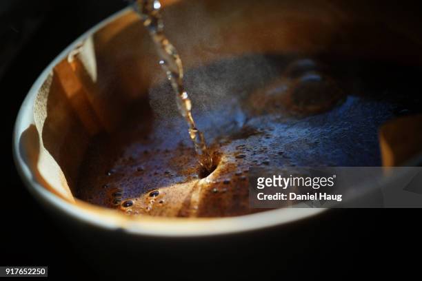 close-up of brewing coffee using a pour-over technique - coffee crop foto e immagini stock