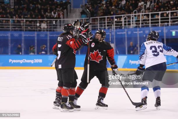 Melodie Daoust of Canada celebrates with teammates after scoring a goal in the second period against Finland during the Women's Ice Hockey...
