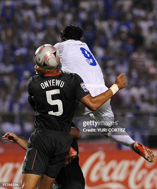 Honduran Carlos Pavon vies with Oguchi Onyewu of the US during their FIFA World Cup South Africa 2010 Concacaf qualifier football match at Olimpico...