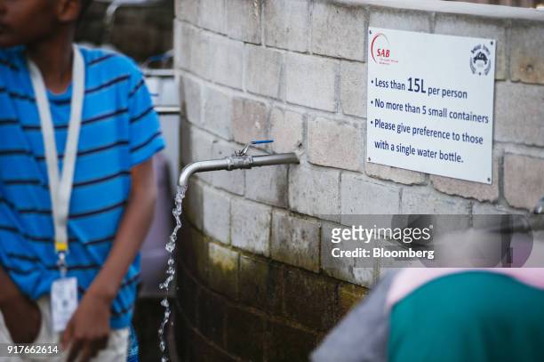 Water runs from a pipe outlet at a natural water spring on the site of SABMiller Plc's Newlands brewery in Cape Town, South Africa, on Wednesday,...
