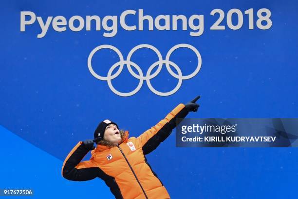 Netherlands' gold medallist Ireen Wust celebrates on the podium during the medal ceremony for the speed skating women's 1500m at the Pyeongchang...