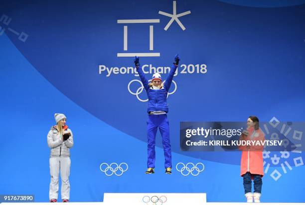 Germany's silver medallist Katharina Althaus, Norway's gold medallist Maren Lundby and Japan's bronze medallist Sara Takanashi pose on the podium...