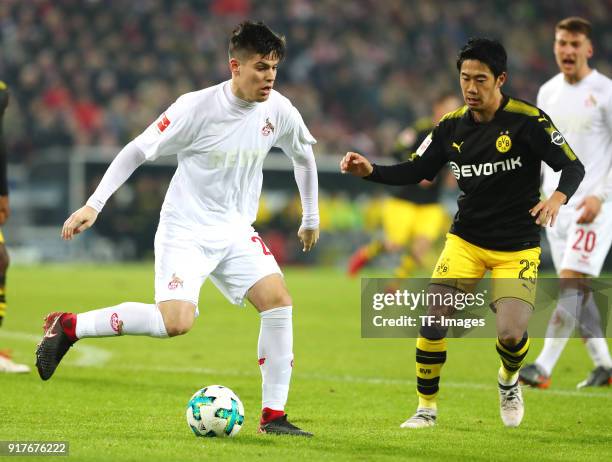 Jorge Mere of Koeln and Shinji Kagawa of Dortmund battle for the ball during the Bundesliga match between 1. FC Koeln and Borussia Dortmund at...