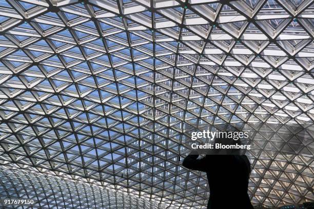 Guest takes a photograph of the roof of the Spectacle atrium at the MGM Cotai casino resort, developed by MGM China Holdings Ltd., in Macau, China,...