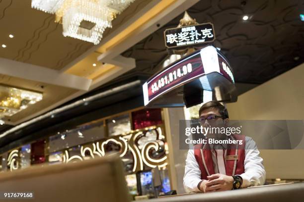 Dealer sits at a blackjack table on the gaming floor of the casino at the MGM Cotai casino resort, developed by MGM China Holdings Ltd., in Macau,...