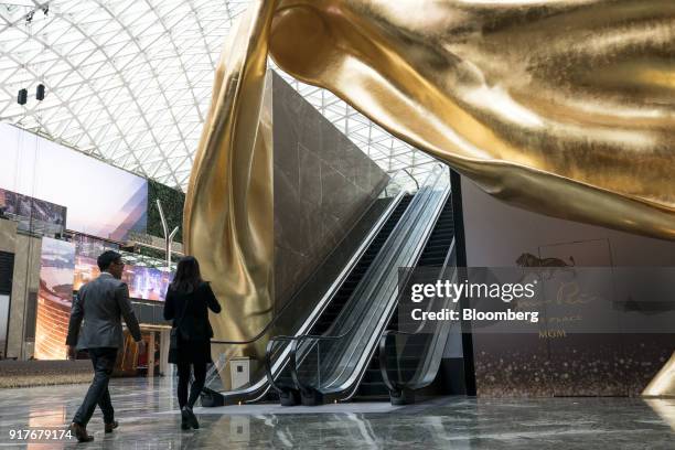 People walk through the Spectacle atrium at the MGM Cotai casino resort, developed by MGM China Holdings Ltd., in Macau, China, on Tuesday, Feb. 13,...