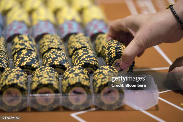 Dealer handles gaming chips on the floor of the casino at the MGM Cotai casino resort, developed by MGM China Holdings Ltd., in Macau, China, on...