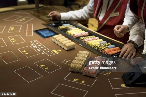 Dealers prepare gaming chips on the floor of the casino at the MGM Cotai casino resort, developed by MGM China Holdings Ltd., in Macau, China, on...