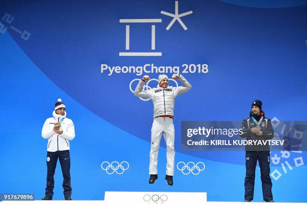 Czech Republic's silver medallist Michal Krcmar, Germany's gold medallist Arnd Peiffer and Italy's bronze medallist Dominik Windisch pose on the...