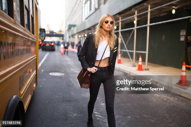 Stella Maxwell is seen on the street attending Zadig & Voltaire during New York Fashion Week wearing a military blazer with white crop top and black...