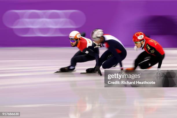 Sjinkie Knegt of the Netherlands, Ziwei Ren of China compete during the Men's 1000m Short Track Speed Skating qualifying on day four of the...