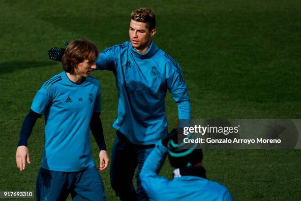 Cristiano Ronaldo of Real Madrid CF jokes with his teammate Luka Modric during a training session at Valdebebas training ground ahead their Round of...