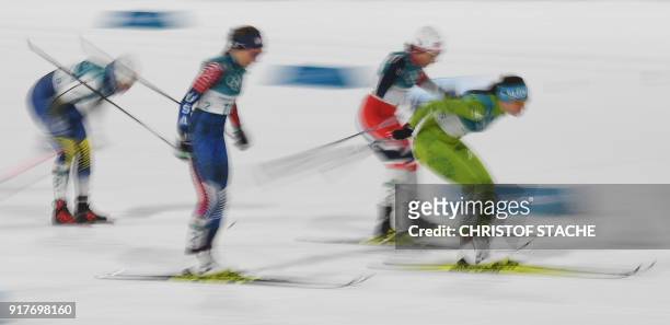 S Simeon Hamilton and Slovenia's Katja Visnar compete during the women's cross-country individual sprint classic quarterfinal at the Alpensia cross...